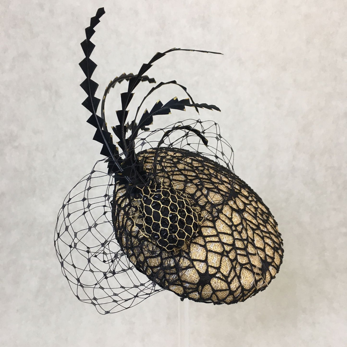 Barbara: Slanted Cocktail Fascinator with Gold Base and Spider Netting, Accented with Feather Spray