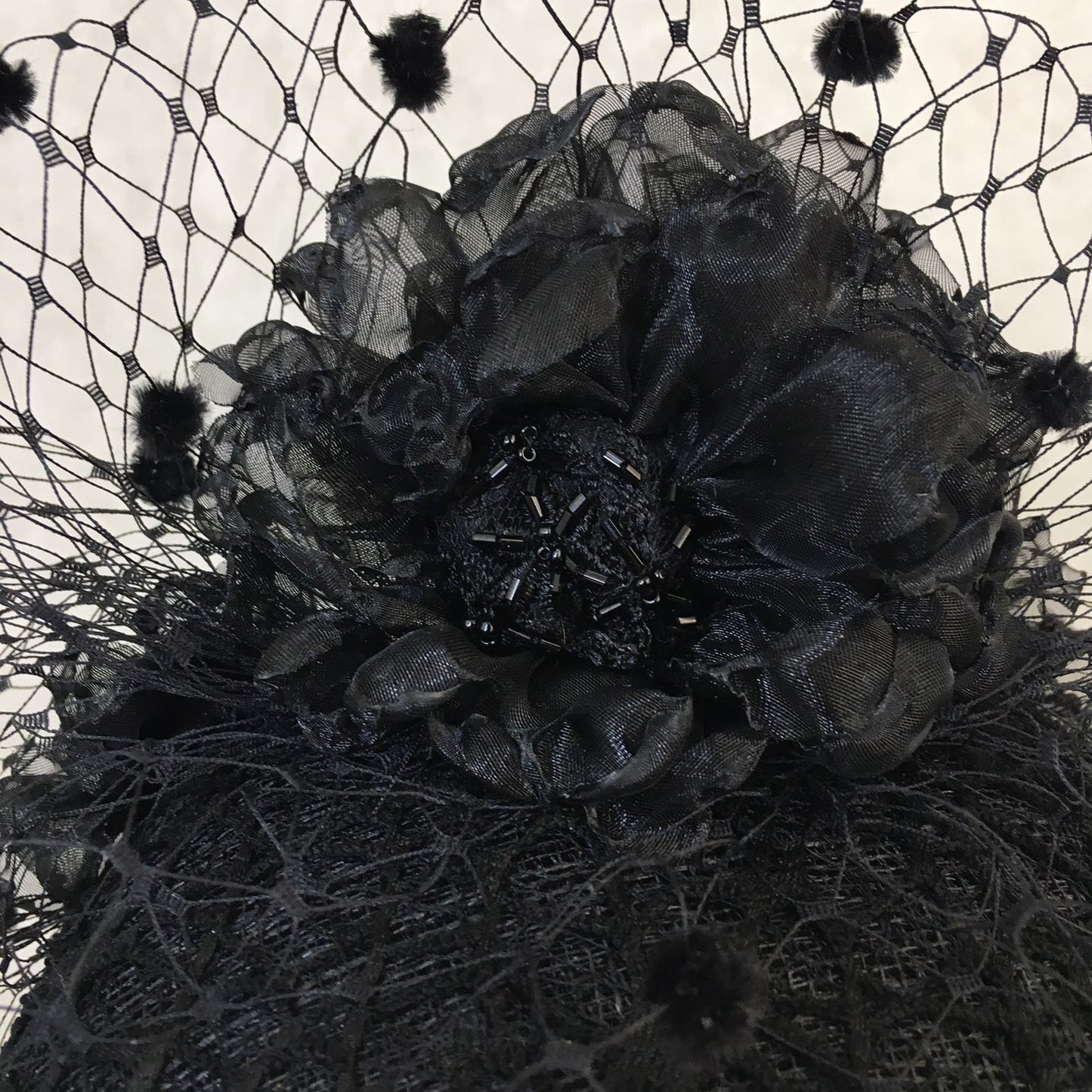 Beatrice: Black Dome Cocktail Fascinator with Black Spotted Veiling Trimmed with Hand Made Flowers