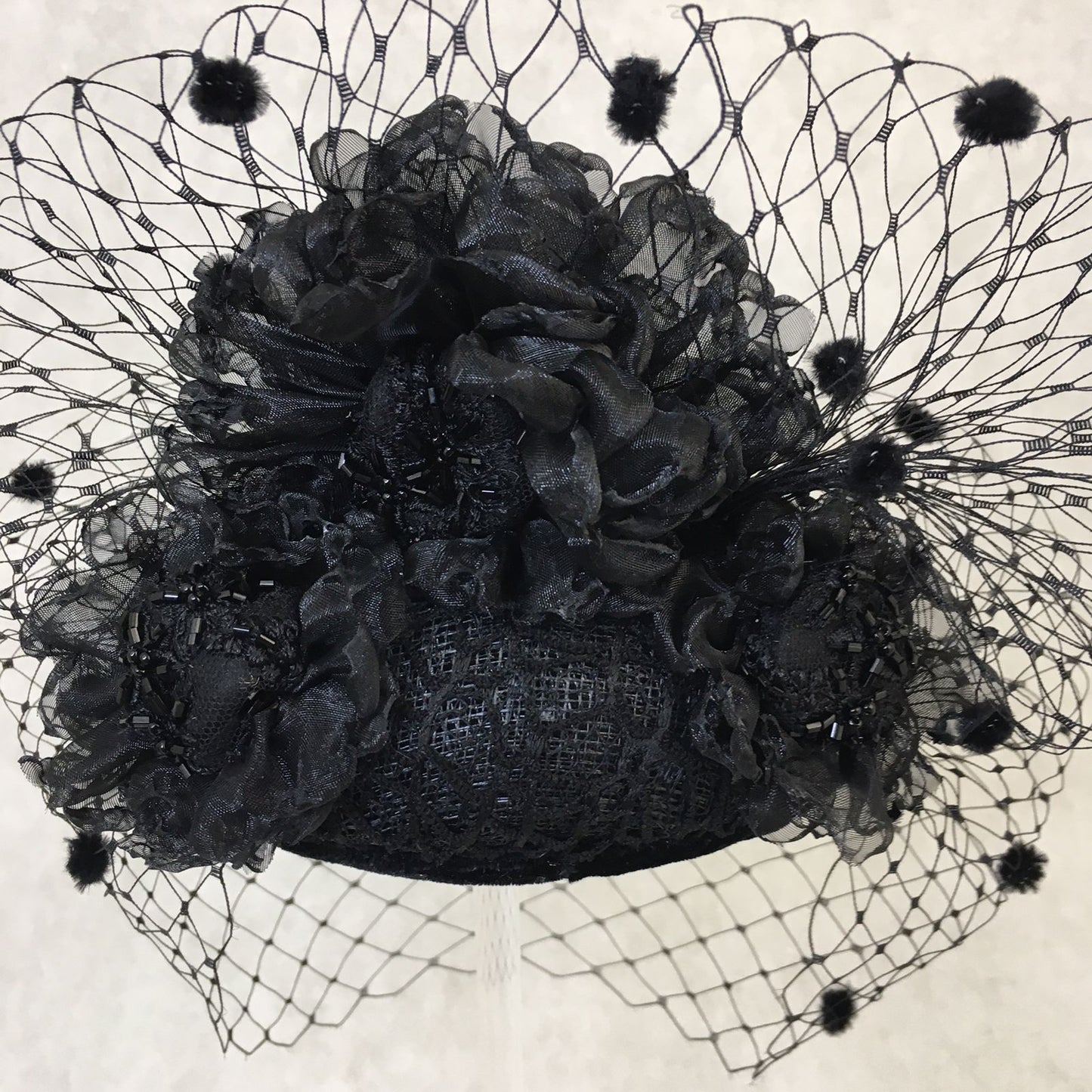 Beatrice: Black Dome Cocktail Fascinator with Black Spotted Veiling Trimmed with Hand Made Flowers