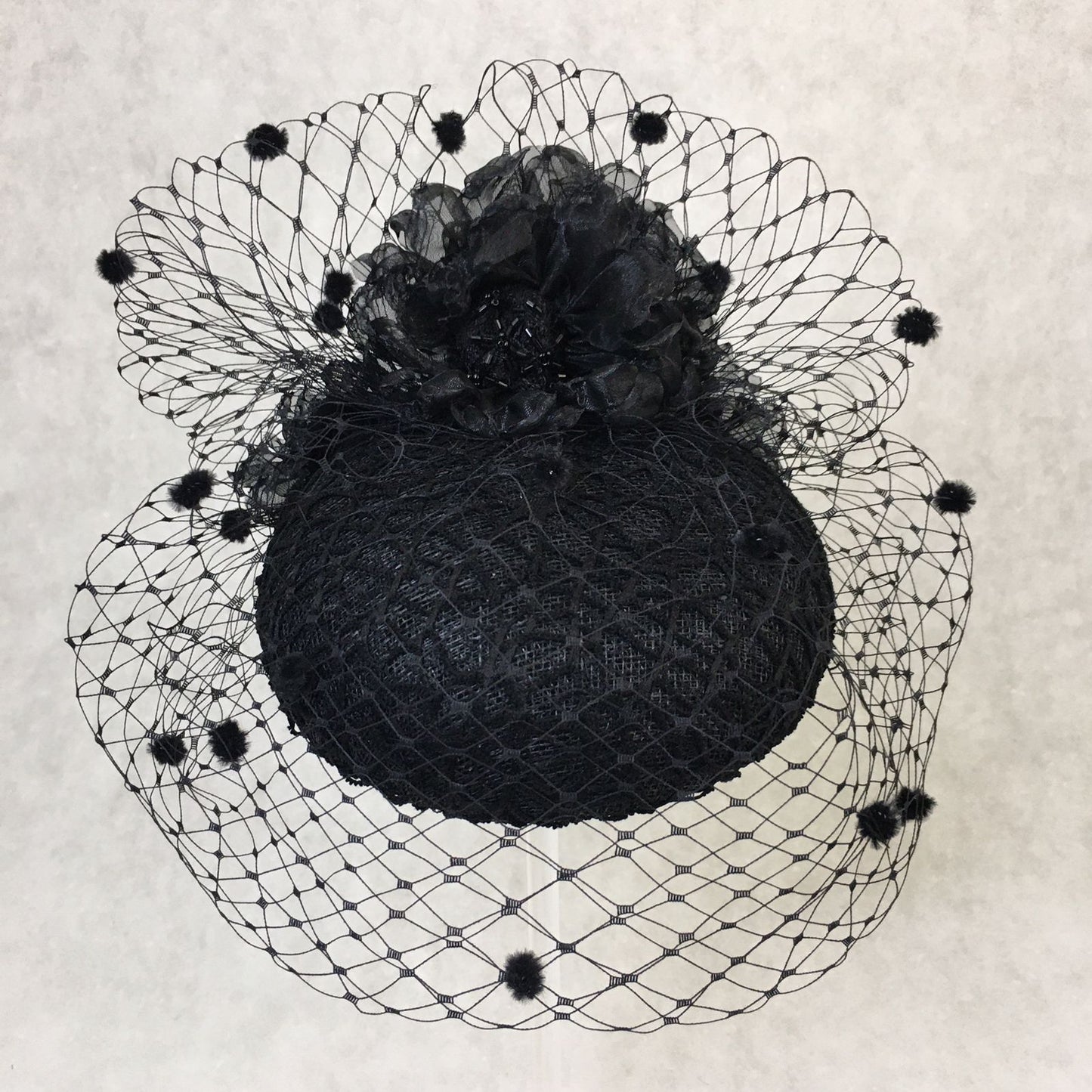 Beatrice: Black Dome Cocktail Fascinator with Black Spotted Veiling Trimmed with Hand Made Flowers