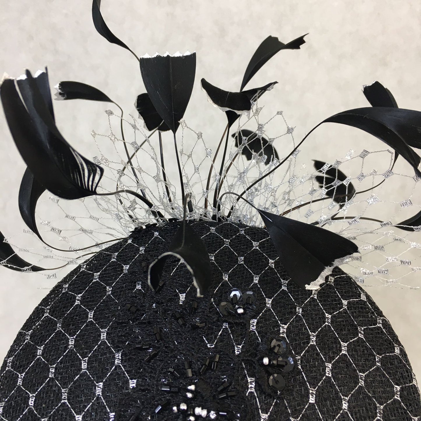 Bethany: Black and Silver Slanted Cocktail Fascinator Accented with Hand Crafted Black Feathers and Silver Veiling