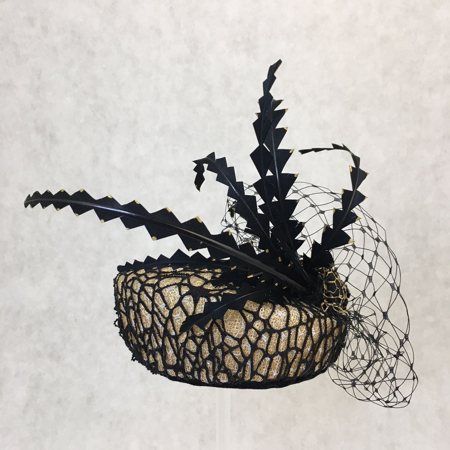 Barbara: Slanted Cocktail Fascinator with Gold Base and Spider Netting, Accented with Feather Spray